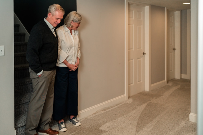 Two Molly Maid customers looking at results from their cleaning appointment.