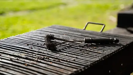 Chicken being cooked on an outdoor charcoal grill
