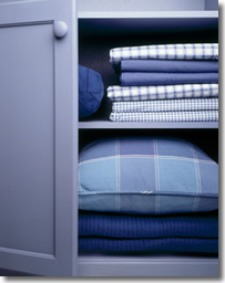 Fitted-Sheet-Neatly-Folded Neatly folded fitted sheets in a linen closet
